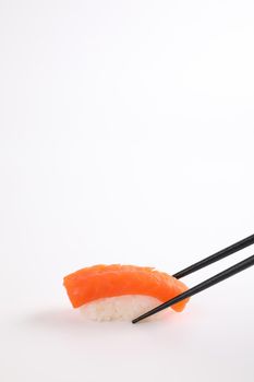 Salmon sushi with chopsticks Japanese food isolated in white background