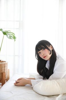 Portrait beautiful asian girl sleeping on bed in white room 