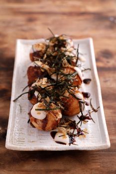 Takoyaki isolated in wood background Japanese food