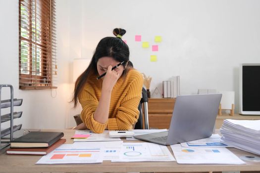 Portrait of Frustrated Business woman have problem while sitting at her working place. Business Stressed concept..