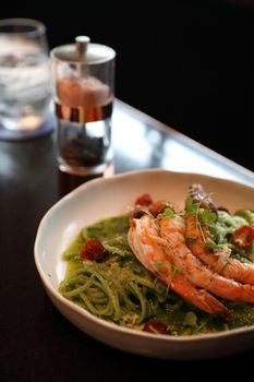 spaghetti pesto sauce with grilled shrimps italian food