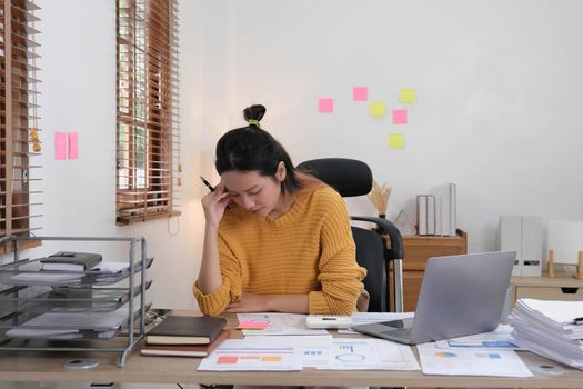 Portrait of Frustrated Business woman have problem while sitting at her working place. Business Stressed concept..