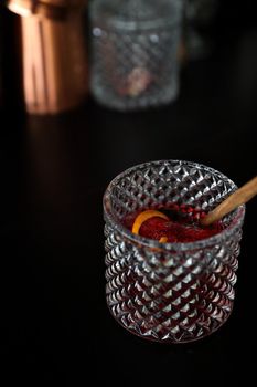 Pink Cocktail glass with ice at a bar counter