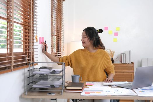 Sticky note paper reminder schedule board. Accountant or business use post it notes to share idea on sticky note. Accounting concept.