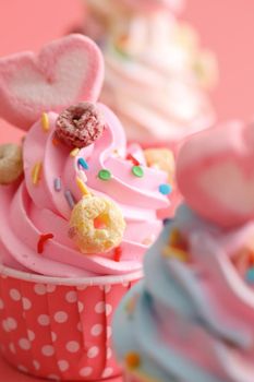 Colorful cupcakes isolated in pink background