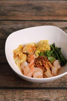 Shrimp dumpling with shrimp on wood background