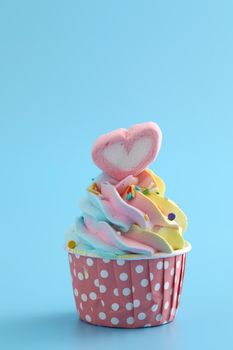 Colorful cupcake isolated in blue background