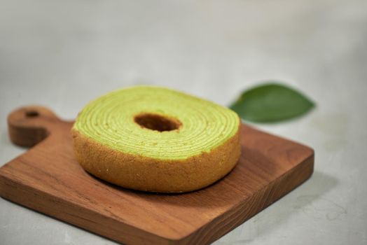 Close up on green matcha Baumkuchen Japanese roll cakes, selective focus