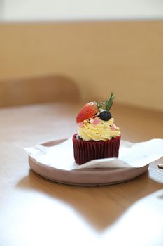 Colorful cupcakes on wood table background