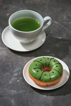 Matcha and white chocolate donuts with matcha tea latte