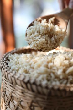 Organic boiled brown rice on Wicker basket in close up