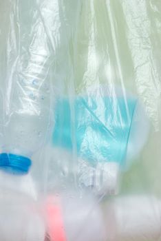 Plastic bag filled with household waste isolated on white background.