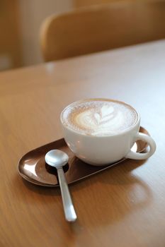 cappuccino or Latte art coffee made from milk on the wood table in coffee shop