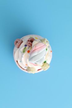 Colorful cupcake isolated in blue background