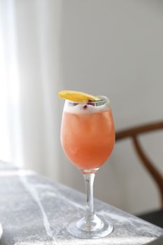 Pink Cocktail glass with ice at gray table