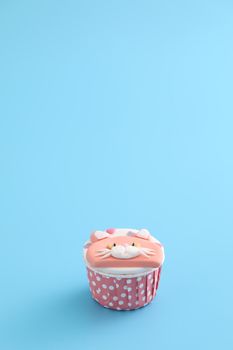 Cute cat cupcake isolated in blue background