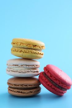 Colorful macarons isolated in blue background