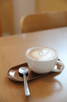 cappuccino or Latte art coffee made from milk on the wood table in coffee shop