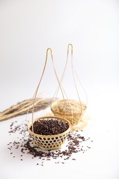 Organic raw brown rice and riceberry rice on Wicker basket in close up