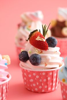 Colorful cupcakes isolated in pink background