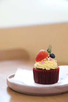 Colorful cupcakes on wood table background