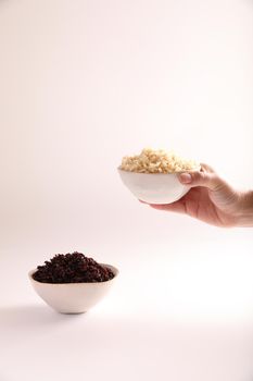 Organic boiled brown rice on bowl isolated in white background