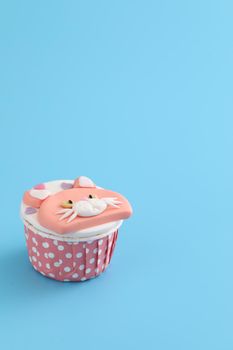 Cute cat cupcake isolated in blue background