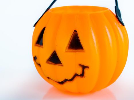 Halloween bag in shape of Jack-o'-lantern on white background.
