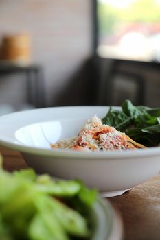 spaghetti Bolognese with italian sausage and tomato sauce with parmesan cheese and basil 