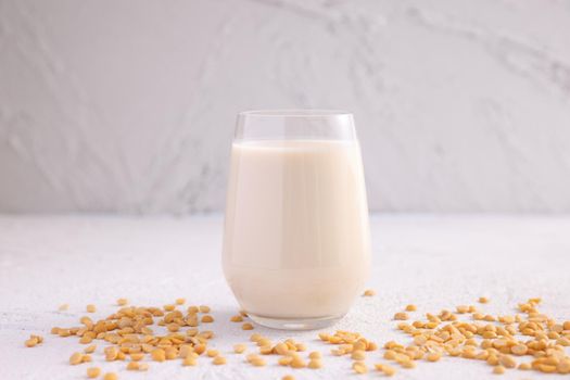 Soy milk in glass and soy bean isolated in white background