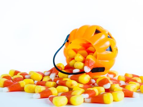 Candy corn candies falling out of Halloween treat bag.