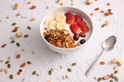 bowl of granola cereal with yogurt and berries isolated on white background