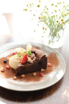 Chocolate cake with ice cream dessert on wood table 