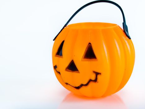 Halloween bag in shape of Jack-o'-lantern on white background.