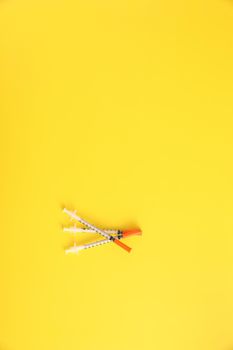 Syringe vaccine isolated in yellow background