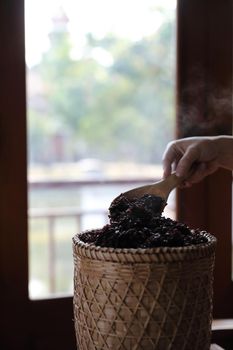 Boiled riceberry rice on Wicker basket with spoon in close up