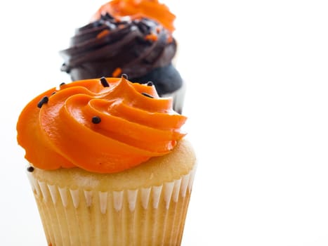 Halloween orange and black cupcakes on white background.