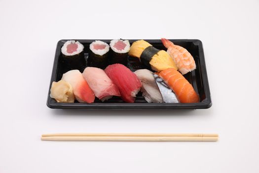 Sushi Set nigiri and sushi rolls with soy sauce and chopsticks Japanese food isolated in white background