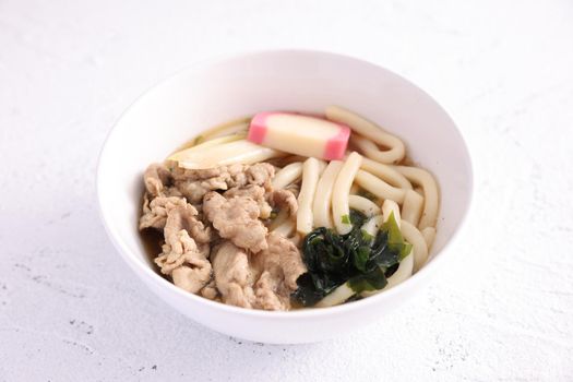 Udon noodles with pork isolated in white background