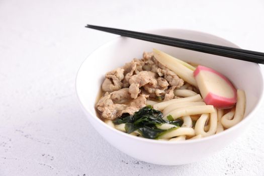 Udon noodles with pork isolated in white background
