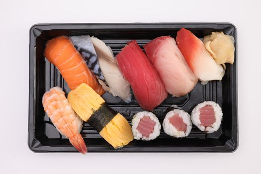 Sushi Set nigiri and sushi rolls with soy sauce and chopsticks Japanese food isolated in white background