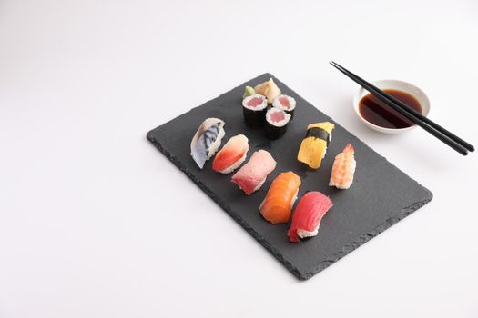 Sushi Set nigiri and sushi rolls with soy sauce and chopsticks Japanese food isolated in white background