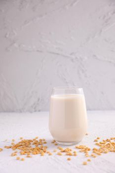 Soy milk in glass and soy bean isolated in white background