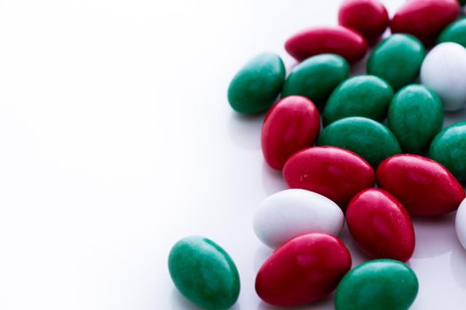 Colorful red, green and white candies on white background.