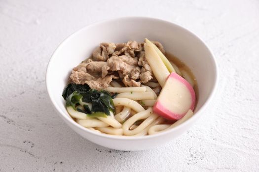 Udon noodles with pork isolated in white background