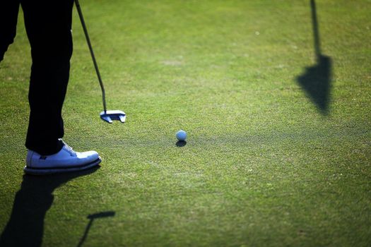 Young male golfer player on golf course