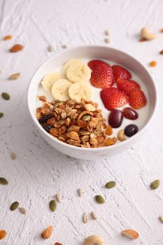 bowl of granola cereal with yogurt and berries isolated on white background