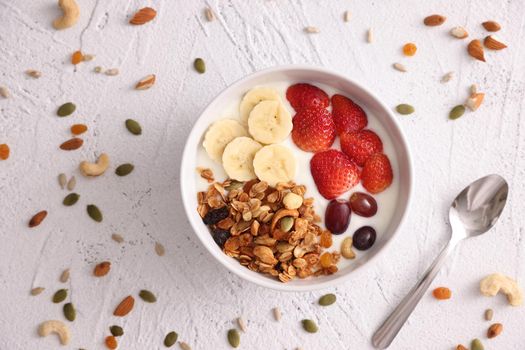 bowl of granola cereal with yogurt and berries isolated on white background