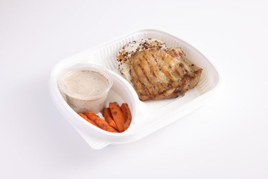 Grilled chicken with rice with delivery package isolated in white background