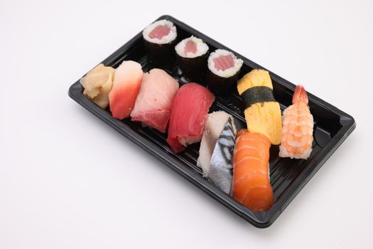 Sushi Set nigiri and sushi rolls with soy sauce and chopsticks Japanese food isolated in white background